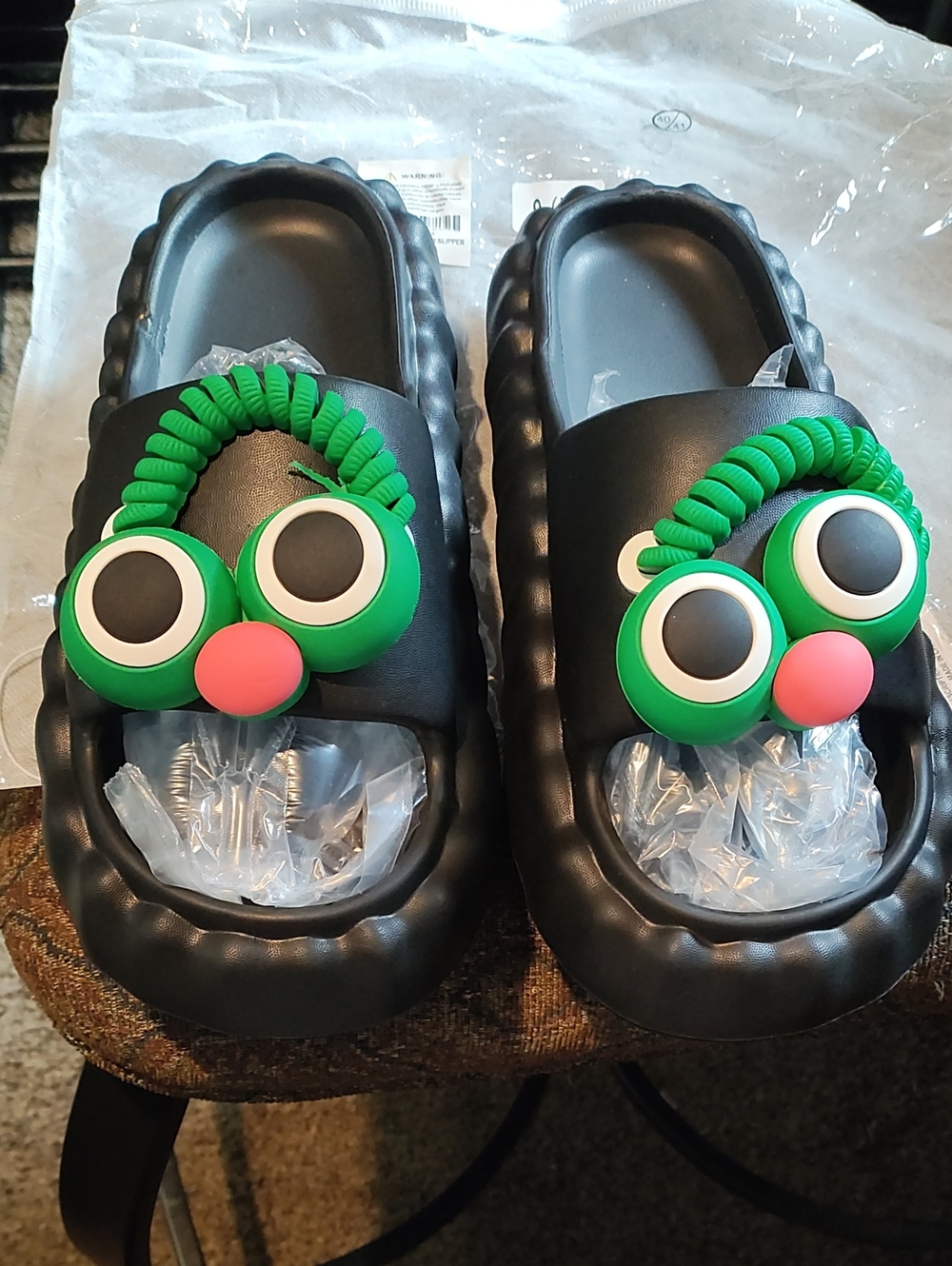 J.O.A Women's Black Slip-On In Door Slippers with Green Character Accent